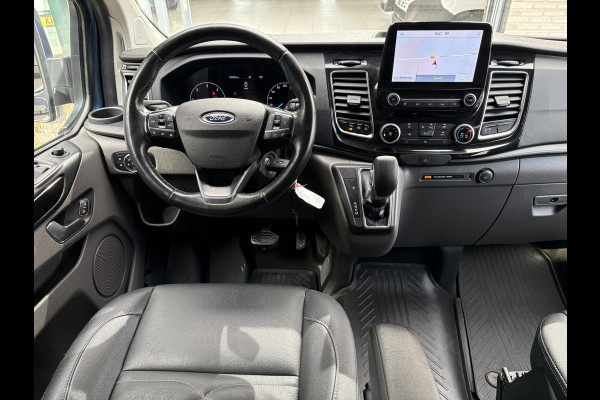 Ford Transit Custom 320 2.0 TDCI L2H1 Platinum Edition DC Automaat Achteruitrijcamera - Parkeersensoren - Navigatie - Airco - Dodehoek detector - Cruise control - Licht metalen velgen 16 inch - Lederen bekleding - Radio - Bluetooth - Dubbele cabine - Tussens - Mistlampen voor - Sidebars - Trekhaak - Voorstoelen verwarmd - Led verlichting - Extra getint glas achter - Start/stop systeem - Stuur multifunctioneel - Stuur leder - Regensensor