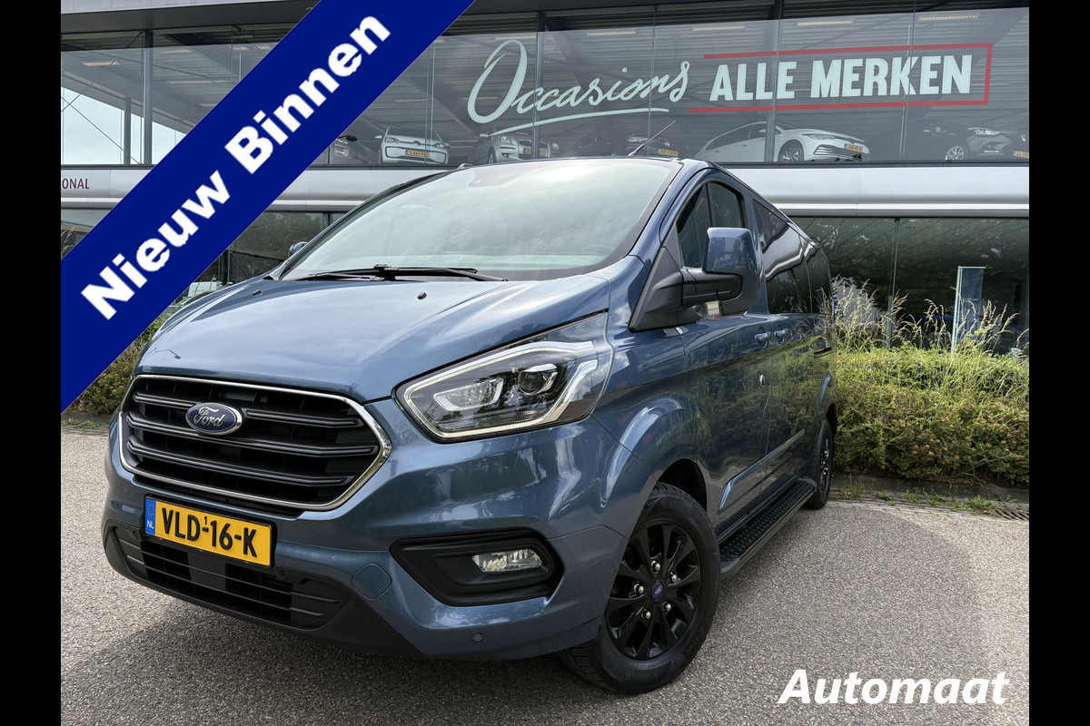 Ford Transit Custom 320 2.0 TDCI L2H1 Platinum Edition DC Automaat Achteruitrijcamera - Parkeersensoren - Navigatie - Airco - Dodehoek detector - Cruise control - Licht metalen velgen 16 inch - Lederen bekleding - Radio - Bluetooth - Dubbele cabine - Tussens - Mistlampen voor - Sidebars - Trekhaak - Voorstoelen verwarmd - Led verlichting - Extra getint glas achter - Start/stop systeem - Stuur multifunctioneel - Stuur leder - Regensensor
