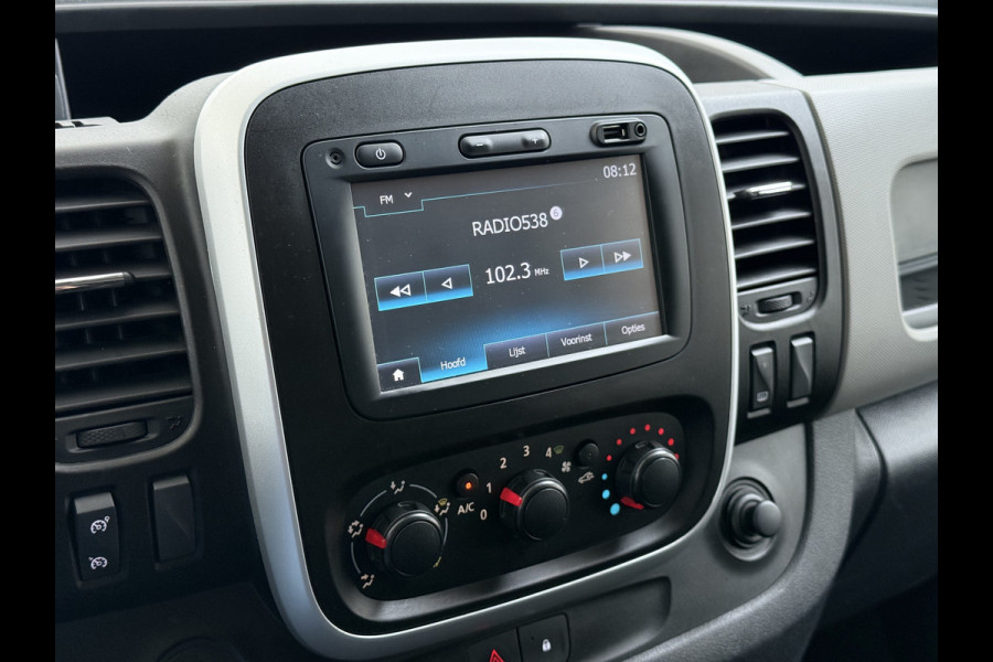 Renault Trafic 1.6dCi T29 L2H1 3-Persoons Trekhaak Euro 6 Navi Airco Cruise Control Bluetooth Pdc Comfort Regen-Lichtsensor Betonplex Vloer Lat om Lat Wandbetimmering Schuifdeur 2.000KG Trekgewicht Origineel Nederlandse Auto