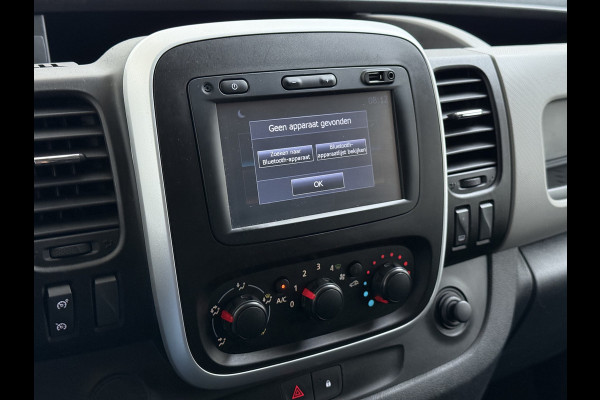 Renault Trafic 1.6dCi T29 L2H1 3-Persoons Trekhaak Euro 6 Navi Airco Cruise Control Bluetooth Pdc Comfort Regen-Lichtsensor Betonplex Vloer Lat om Lat Wandbetimmering Schuifdeur 2.000KG Trekgewicht Origineel Nederlandse Auto