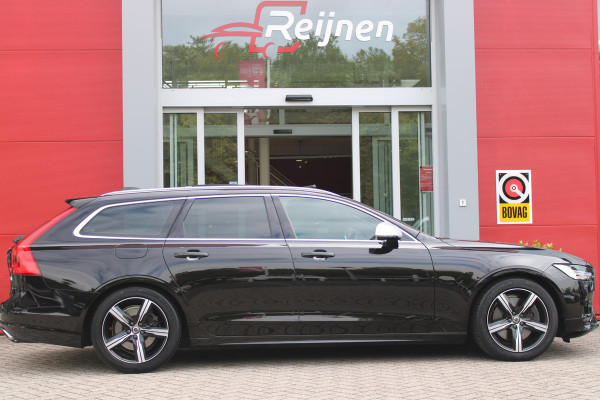 Volvo V90 2.0 T4 190PK R-Design | PANORAMISCH SCHUIF/KANTEL DAK | HARMAN KARDON PREMIUM AUDIO | ELEKTRSICHE VOORSTOELEN MET GEHEUGEN FUNCTIE | STOEL/STUUR VERWARMING | ACHTERBANK VERWARMING | HEAD-UP DISPLAY | MISTLAMPEN VOOR | KEYLESS ENTRY / START | APPLE CARPLAY | ADROID AUTO | ELEKTRISCH BEDIENBARE ACHTERKLEP | ACHTERUITRIJCAMERA | STANDKACHEL |