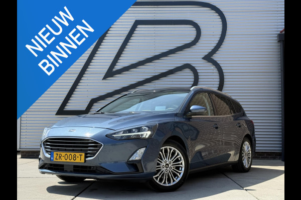 Ford FOCUS Wagon 1.0 EcoBoost Titanium Business 2e Eigenaar|Pano|Stoel+stuurverw|Adap Cruise|Carplay|HUD|Dealer Onderhouden|Camera|Clima|PDC V+A|Trekhaak|LM velgen|Navi|Elek Ramen|N.A.P.|APK tot 07-2027