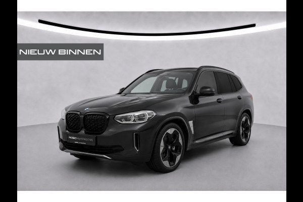 BMW iX3 High Executive 80 kWh | Panoramadak | Harman Kardon | Head-Up Display | Adaptive Cruise Control | Stoelverwarming | Dodehoekdetectie | Keyless | Trekhaak | Adaptief Onderstel | 360 Camera | Ambiance Verlichting |