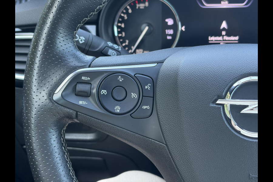 Opel Astra Sports Tourer 1.2 Ultimate 2e Eigenaar l Trekhaak l Camera l Carplay l Navi l Alcantara-Leder l 17''Lmv l Stoelverw-Stuurverw l Net beurt gehad l Dodehoek l Rijstrooksensor l Pdc V+A l 6 Bak l N.A.P l 146pk l Bj 11-2020 l Apk tot 08-2028