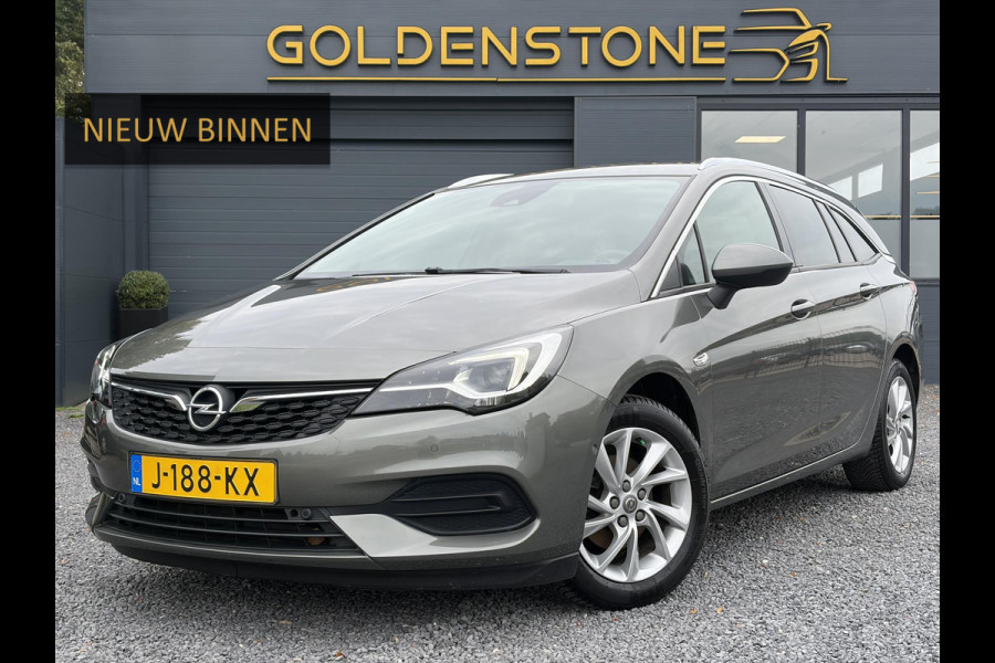 Opel Astra Sports Tourer 1.2 Elegance ✓131pk✓2e Eigenaar✓Camera✓Carplay✓6 Bak✓Stoelverw✓Stuurverw✓Pdc V+A✓Recent beurt gehad✓Clima✓Cruise✓Halfleder✓Keyless✓N.A.P✓Lm velgen✓Rijstrooksensor✓Apk tot 07-2027