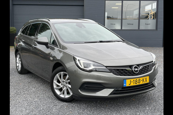 Opel Astra Sports Tourer 1.2 Elegance ✓131pk✓2e Eigenaar✓Camera✓Carplay✓6 Bak✓Stoelverw✓Stuurverw✓Pdc V+A✓Recent beurt gehad✓Clima✓Cruise✓Halfleder✓Keyless✓N.A.P✓Lm velgen✓Rijstrooksensor✓Apk tot 07-2027