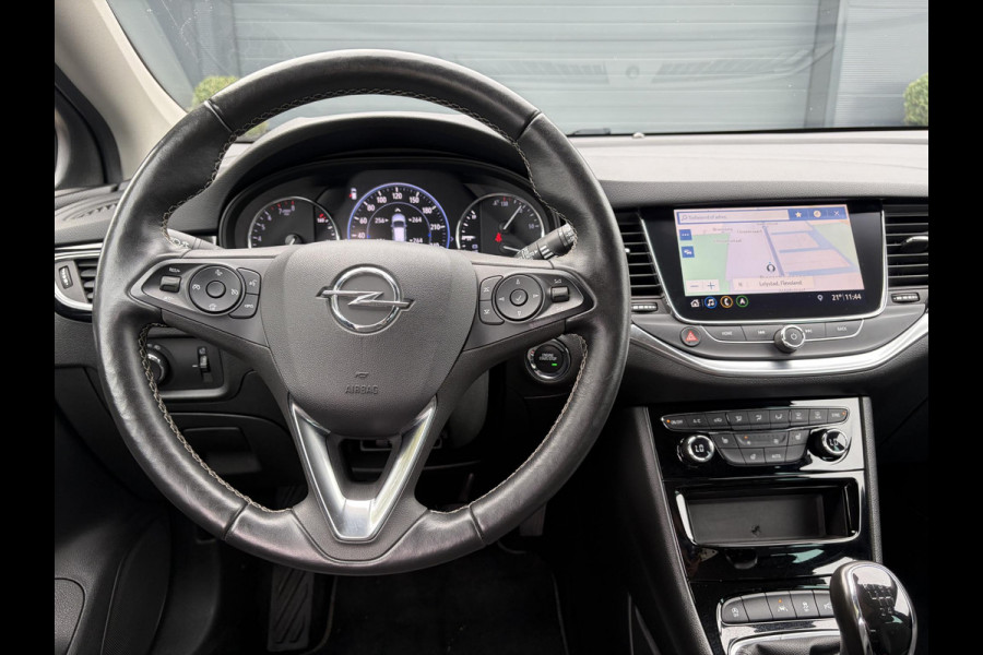 Opel Astra Sports Tourer 1.2 Elegance ✓131pk✓2e Eigenaar✓Camera✓Carplay✓6 Bak✓Stoelverw✓Stuurverw✓Pdc V+A✓Recent beurt gehad✓Clima✓Cruise✓Halfleder✓Keyless✓N.A.P✓Lm velgen✓Rijstrooksensor✓Apk tot 07-2027