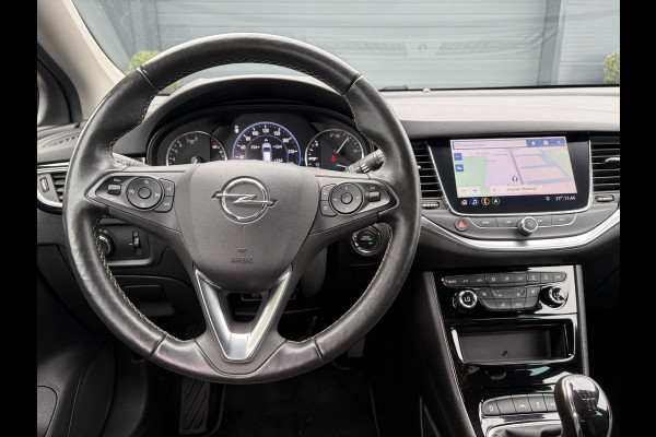 Opel Astra Sports Tourer 1.2 Elegance ✓131pk✓2e Eigenaar✓Camera✓Carplay✓6 Bak✓Stoelverw✓Stuurverw✓Pdc V+A✓Recent beurt gehad✓Clima✓Cruise✓Halfleder✓Keyless✓N.A.P✓Lm velgen✓Rijstrooksensor✓Apk tot 07-2027