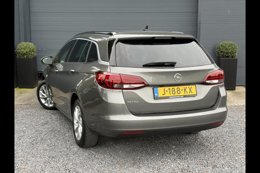 Opel Astra Sports Tourer 1.2 Elegance ✓131pk✓2e Eigenaar✓Camera✓Carplay✓6 Bak✓Stoelverw✓Stuurverw✓Pdc V+A✓Recent beurt gehad✓Clima✓Cruise✓Halfleder✓Keyless✓N.A.P✓Lm velgen✓Rijstrooksensor✓Apk tot 07-2027