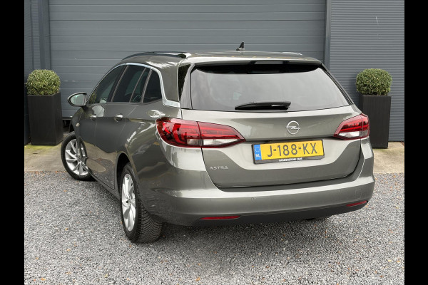 Opel Astra Sports Tourer 1.2 Elegance ✓131pk✓2e Eigenaar✓Camera✓Carplay✓6 Bak✓Stoelverw✓Stuurverw✓Pdc V+A✓Recent beurt gehad✓Clima✓Cruise✓Halfleder✓Keyless✓N.A.P✓Lm velgen✓Rijstrooksensor✓Apk tot 07-2027