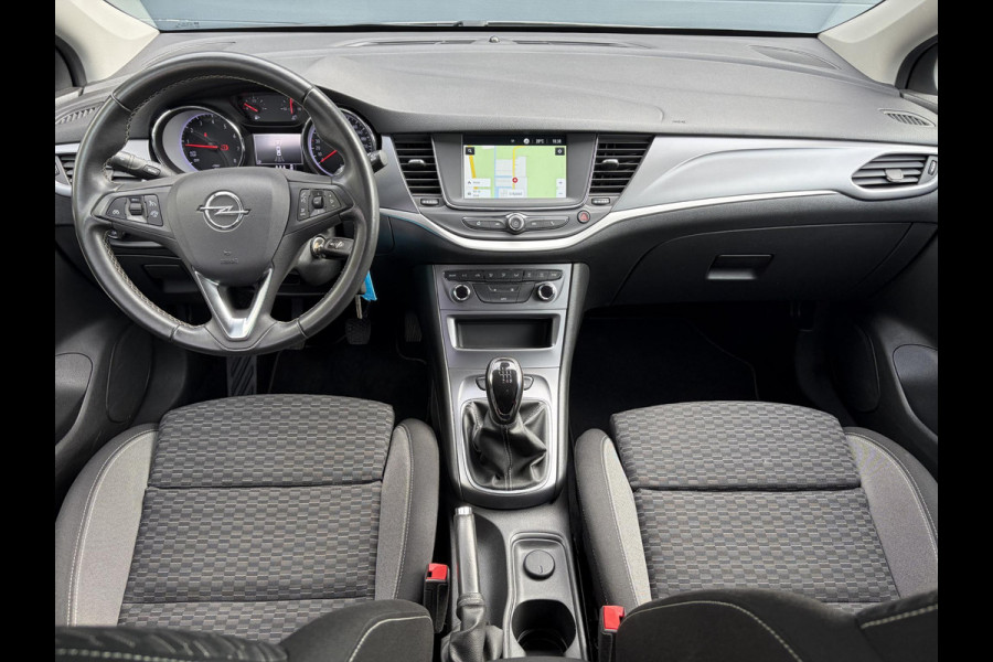 Opel Astra Sports Tourer 1.2 Business Executive ✓1e Eigenaar✓146pk✓Camera✓Trekhaak✓Carplay✓Airco✓Cruise✓Pdc V+A✓Lm velgen✓Comfortstoelen✓6 Bak✓N.A.P✓Nieuwe Apk bij Aflevering