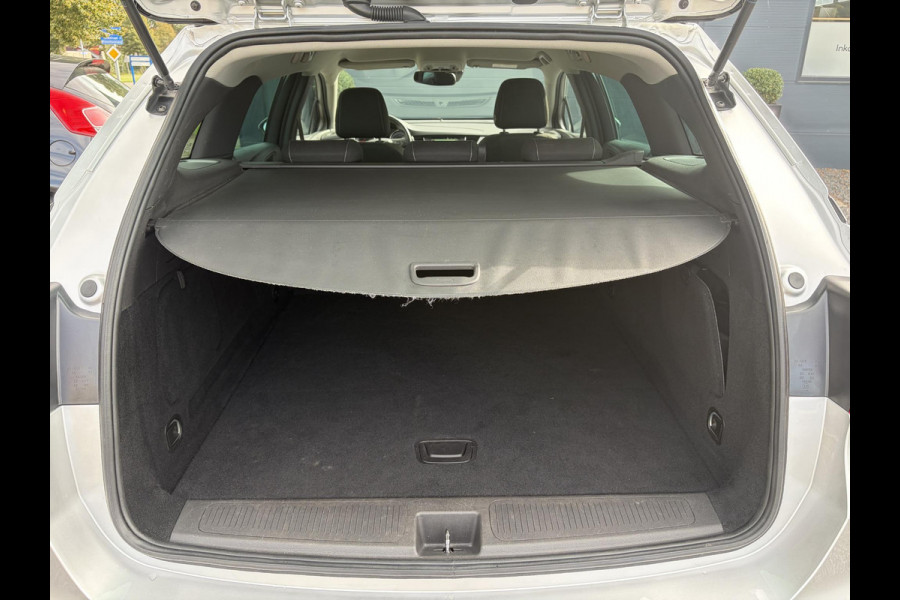 Opel Astra Sports Tourer 1.2 Business Executive ✓1e Eigenaar✓146pk✓Camera✓Trekhaak✓Carplay✓Airco✓Cruise✓Pdc V+A✓Lm velgen✓Comfortstoelen✓6 Bak✓N.A.P✓Nieuwe Apk bij Aflevering