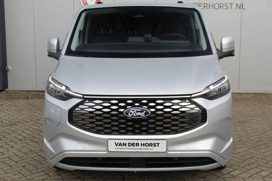 Ford E-Transit Custom 340 L2H1 Limited 71 kWh. Vol elektrisch ! De nieuwe E-Transit Custom is klaar voor de toekomst ! Airco, navigatie, telefoonvoorb., 17" LM wln (meerprijs), 3-zits, camera, parkeersensoren, LED verl., stoel-, stuur-, spiegel- en voorraamverwarming etc.