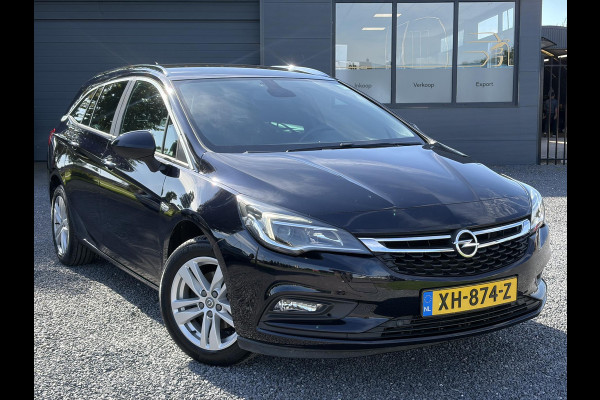 Opel Astra Sports Tourer 1.4 Turbo Online Edition ✓150pk✓2e Eigenaar✓Camera✓Carplay✓Navi✓Pdc V+A✓Stoelverw✓Stuurverw✓Clima✓Cruise✓Lm velgen✓6 Bak✓Comfortstoelen✓Dealer Onderhouden✓N.A.P✓Bj 12-2018✓Apk tot 01-2027