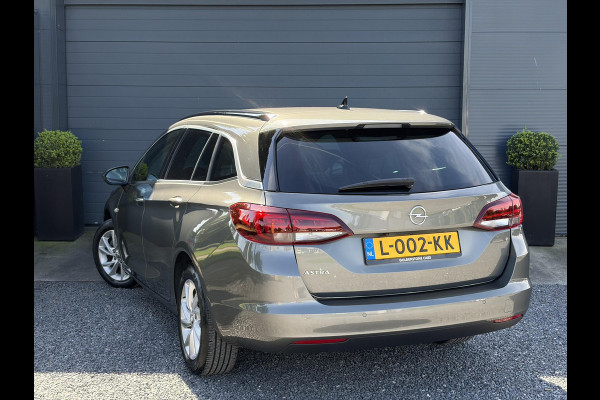 Opel Astra Sports Tourer 1.2 Business Elegance ✓1e Eigenaar✓110pk✓Carplay✓Camera✓Navi✓Clima✓Cruise✓Halfleder✓Comfortstoel✓Pdc V+A✓6 Bak✓Dealer Onderhouden✓Keyless✓Lm velgen✓N.A.P✓Apk tot 06-2027