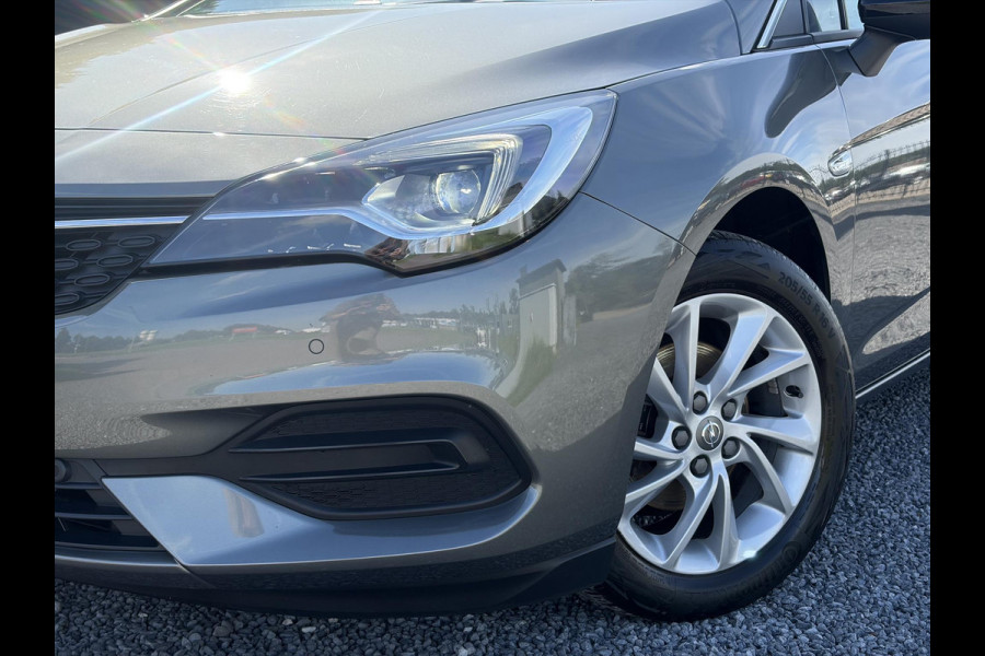 Opel Astra Sports Tourer 1.2 Business Elegance ✓1e Eigenaar✓110pk✓Carplay✓Camera✓Navi✓Clima✓Cruise✓Halfleder✓Comfortstoel✓Pdc V+A✓6 Bak✓Dealer Onderhouden✓Keyless✓Lm velgen✓N.A.P✓Apk tot 06-2027