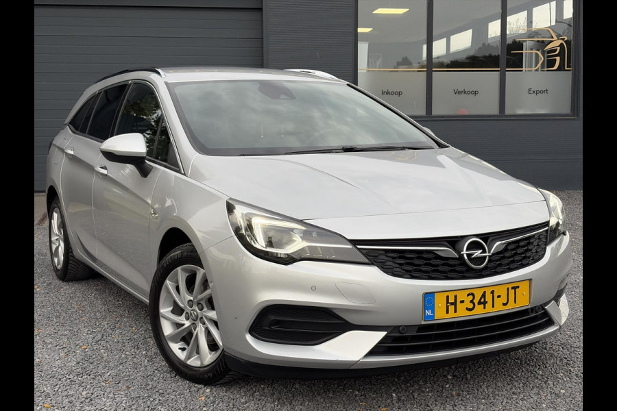 Opel Astra Sports Tourer 1.2 Elegance ✓110pk✓Camera✓Carplay✓Navi✓Halfleder✓Keyless✓Trekhaak✓Pdc V+A✓Clima✓Cruise✓Elekt Stoel✓Recent beurt gehad✓Dodehoeksensor✓Rijstrooksensor✓Lm velgen✓N.A.P✓Apk tot 11-2027