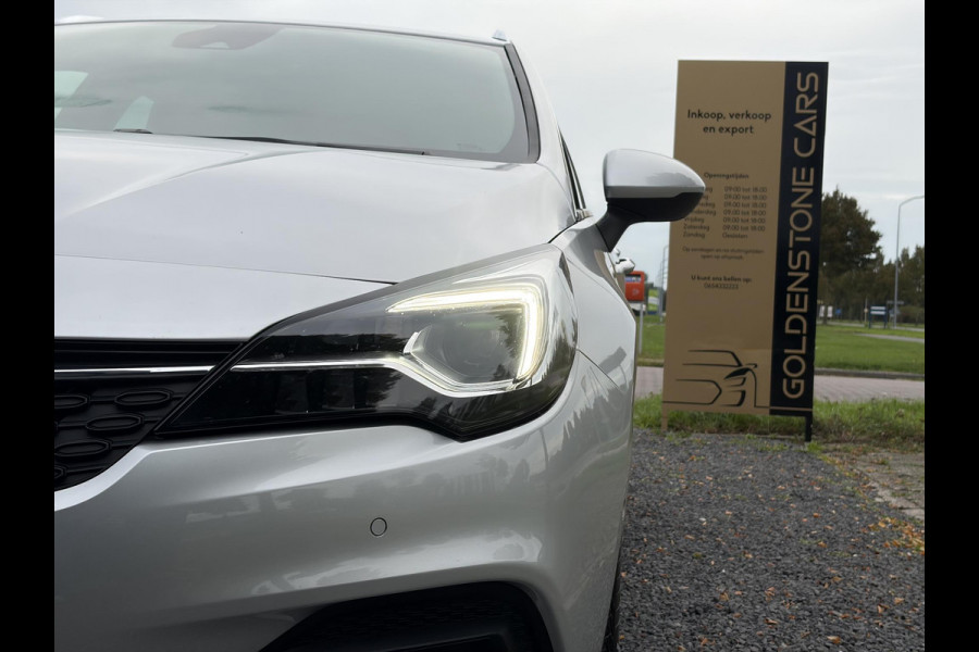 Opel Astra Sports Tourer 1.2 Elegance ✓110pk✓Camera✓Carplay✓Navi✓Halfleder✓Keyless✓Trekhaak✓Pdc V+A✓Clima✓Cruise✓Elekt Stoel✓Recent beurt gehad✓Dodehoeksensor✓Rijstrooksensor✓Lm velgen✓N.A.P✓Apk tot 11-2027