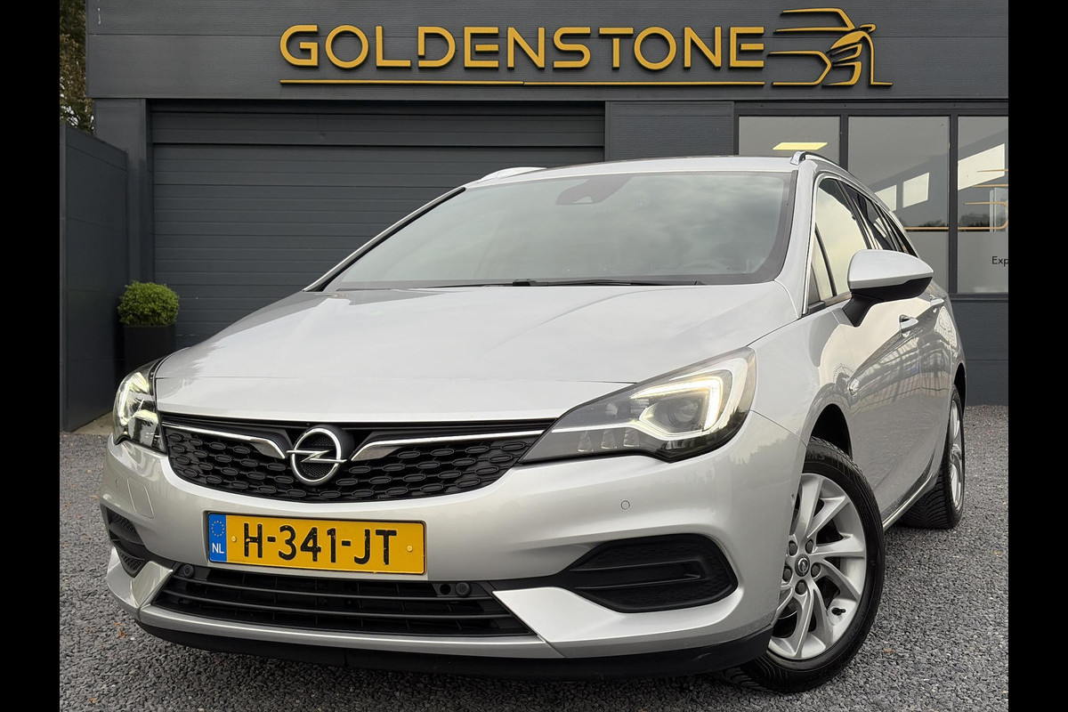 Opel Astra Sports Tourer 1.2 Elegance ✓110pk✓Camera✓Carplay✓Navi✓Halfleder✓Keyless✓Trekhaak✓Pdc V+A✓Clima✓Cruise✓Elekt Stoel✓Recent beurt gehad✓Dodehoeksensor✓Rijstrooksensor✓Lm velgen✓N.A.P✓Apk tot 11-2027