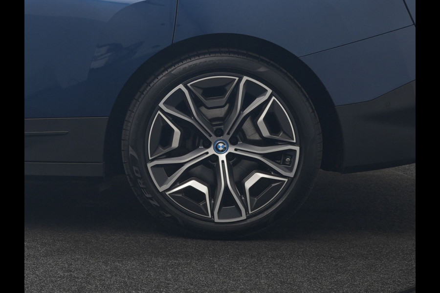 BMW iX xDrive40 Excellence 77 kWh 327pk | SOH 96,9% | Trekhaak Af Fabriek | Panodak Sky Lounge | Adaptive Cruise | Head Up | 360 Camera | Harman / Kardon | Lederen Sportstoelen & Stuur Verwarmd | Sfeerverlichting | BLIS | Keyless |