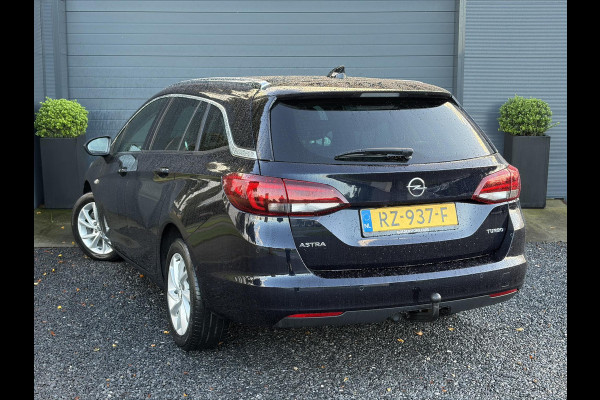 Opel Astra Sports Tourer 1.4 Innovation ✓Trekhaak✓Camera✓Carplay✓Navi✓Recent beurt gehad✓150pk✓Keyless✓Halfleder✓6 Bak✓Rijstrooksensor✓Dodehoeksensor✓Pdc V+A✓Lm velgen✓Clima✓Cruise✓N.A.P✓Apk tot 09-2027