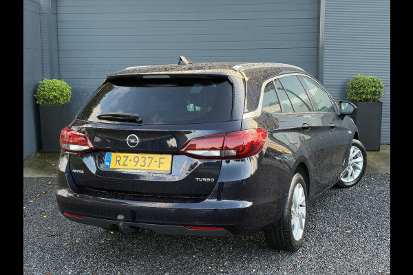 Opel Astra Sports Tourer 1.4 Innovation ✓Trekhaak✓Camera✓Carplay✓Navi✓Recent beurt gehad✓150pk✓Keyless✓Halfleder✓6 Bak✓Rijstrooksensor✓Dodehoeksensor✓Pdc V+A✓Lm velgen✓Clima✓Cruise✓N.A.P✓Apk tot 09-2027