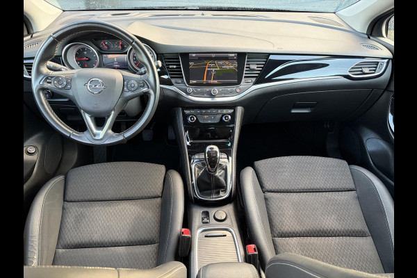 Opel Astra Sports Tourer 1.4 Innovation ✓Trekhaak✓Camera✓Carplay✓Navi✓Recent beurt gehad✓150pk✓Keyless✓Halfleder✓6 Bak✓Rijstrooksensor✓Dodehoeksensor✓Pdc V+A✓Lm velgen✓Clima✓Cruise✓N.A.P✓Apk tot 09-2027