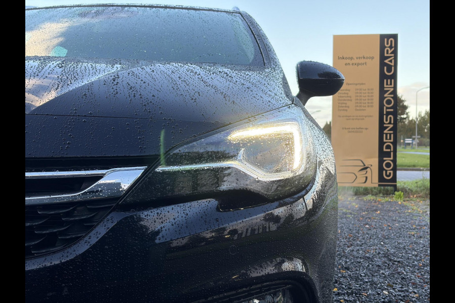 Opel Astra Sports Tourer 1.4 Innovation ✓Trekhaak✓Camera✓Carplay✓Navi✓Recent beurt gehad✓150pk✓Keyless✓Halfleder✓6 Bak✓Rijstrooksensor✓Dodehoeksensor✓Pdc V+A✓Lm velgen✓Clima✓Cruise✓N.A.P✓Apk tot 09-2027