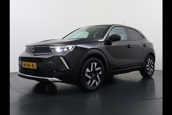 Opel Mokka-e 136PK Automaat Adap.Cruise Warmtepomp Leder 360°Camera Stoelverwarming Navi Android Auto Apple Carplay 50kWh SOH 87% Business El Ecc Privacy Glas Led Isofix DAB Bluetooth Lmv 17" Regen-Lichtsensor Lane Assist 1e Eigenaar Dealeronderhouden Origineel Nederlandse Auto