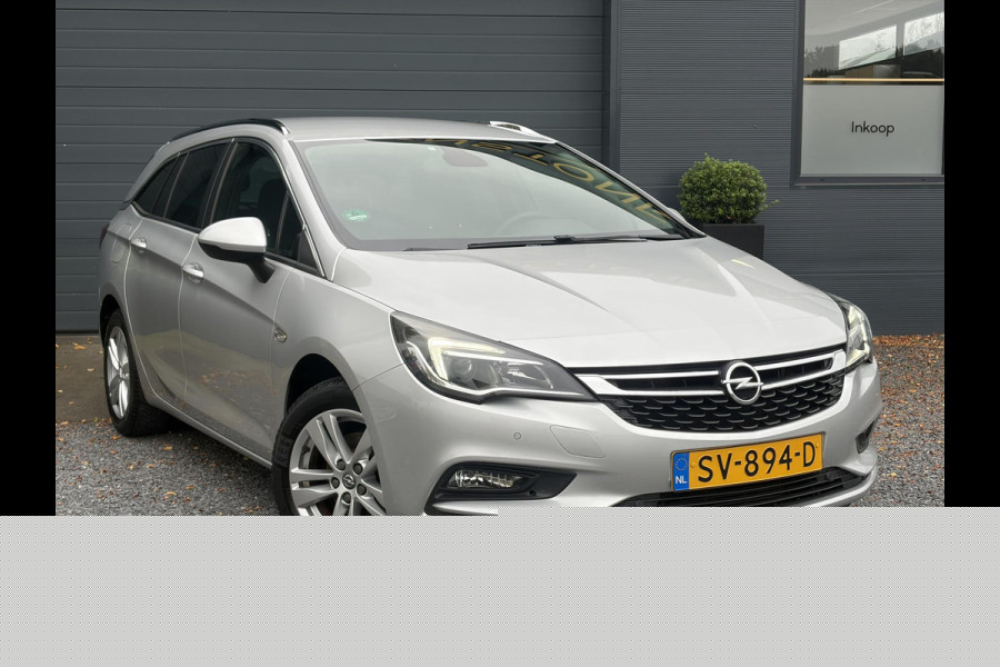Opel Astra Sports Tourer 1.4 Online Edition ✓2e Eigenaar✓Trekhaak✓Carplay✓Navi✓Recent beurt gehad✓150pk✓Keyless✓6 Bak✓Rijstrooksensor✓Dodehoeksensor✓Pdc V+A✓Lm velgen✓Clima✓Cruise✓N.A.P✓Apk tot 06-2027